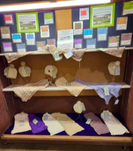 State Fair 2023 display of Salem Millstream Knitting Guild's aran sampler scarves