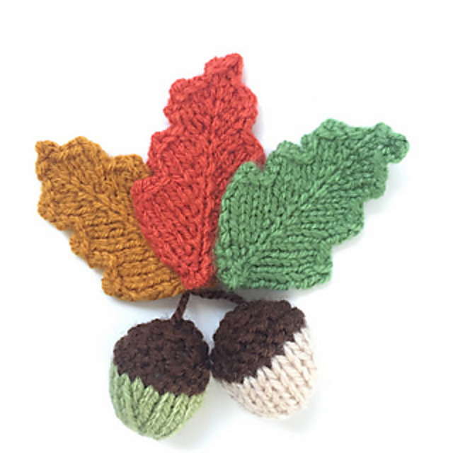 knitted leaves and acorns in fall colors of yellow, orange, green, and brown